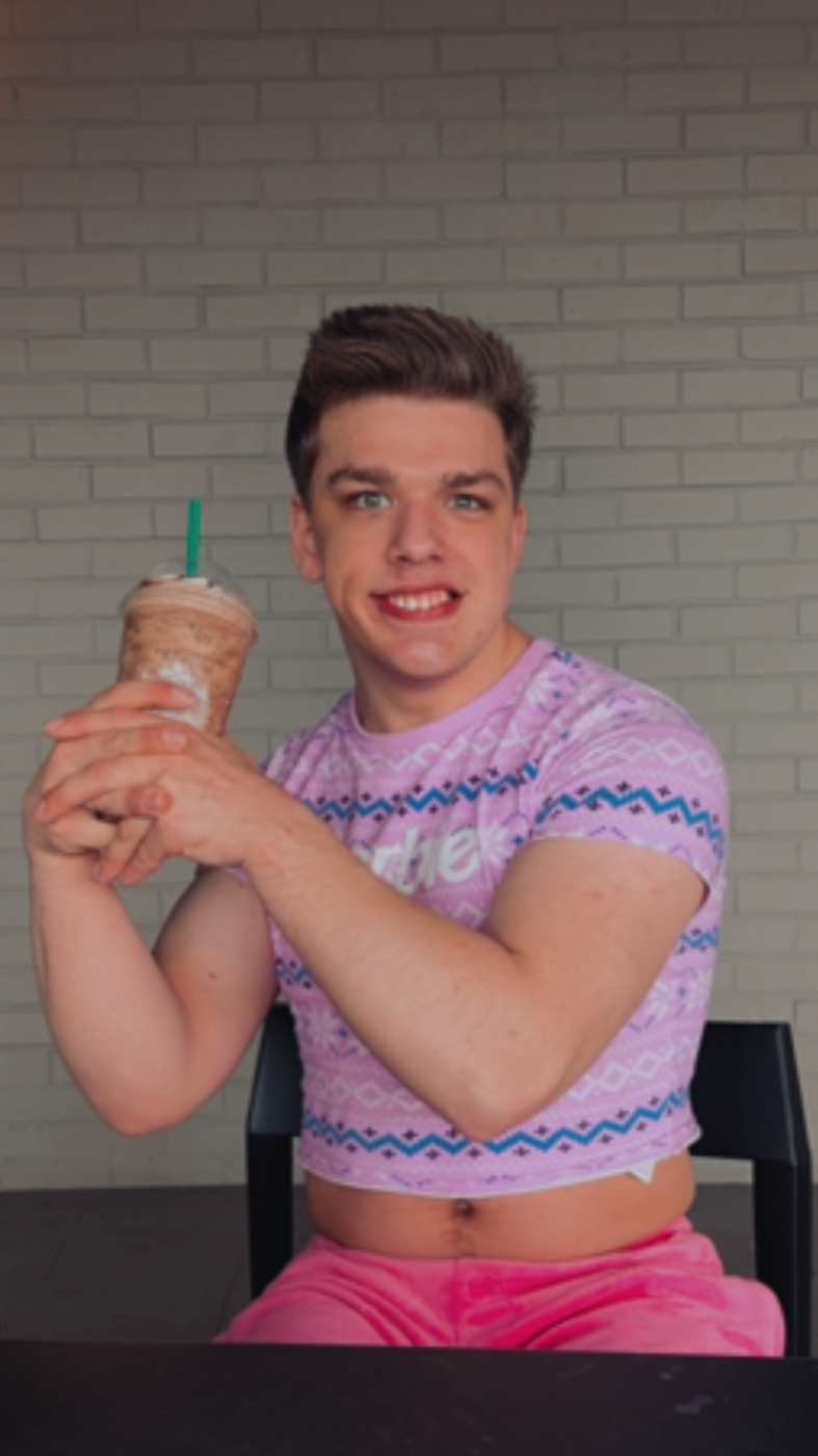 Tobie Smile holding a Frappuccino